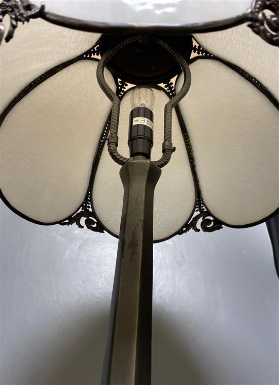 An Art Nouveau style metal table lamp with opaque white glass petal shade